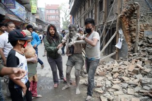 epaselect epa04719891 People free a man from the rubble of a destroyed building after an earthquake hit Nepal, in Kathmandu, Nepal, 25 April 2015. A 7.9-magnitude earthquake rocked Nepal destroying buildings in Kathmandu and surrounding areas, with unconfirmed rumours of casualties. The epicentre was 80 kilometres north-west of Kathmandu, United States Geological Survey. Strong tremors were also felt in large areas of northern and eastern India and Bangladesh.  EPA/NARENDRA SHRESTHA